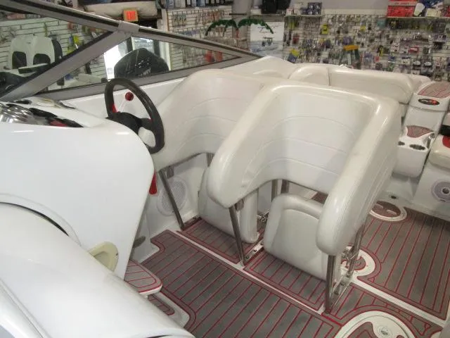 Slide: The Image of 2001 Baja 292 Islander boat interior with white seating and steering wheel. - 7