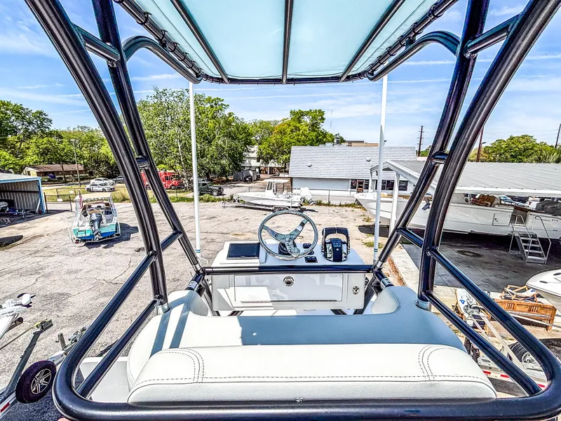 Slide: The Image of 2022 Invincible 36 Open Fisherman boat helm view, showcasing steering and controls. - 14