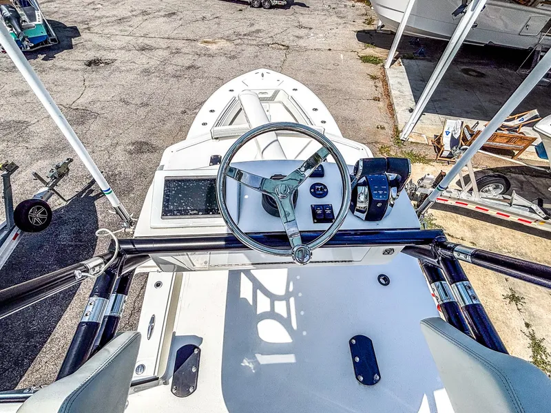 Slide: The Image of 2022 Invincible 36 Open Fisherman boat helm with steering wheel and controls. - 15