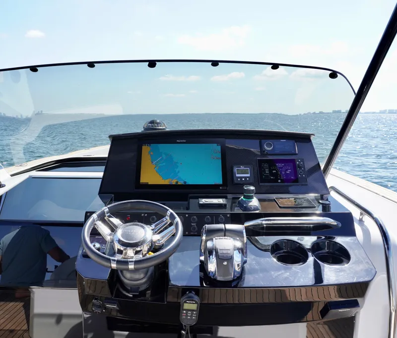 Slide: The Image of Helm of 2020 Pardo Yachts 38 with navigation display, steering wheel, and controls. - 13
