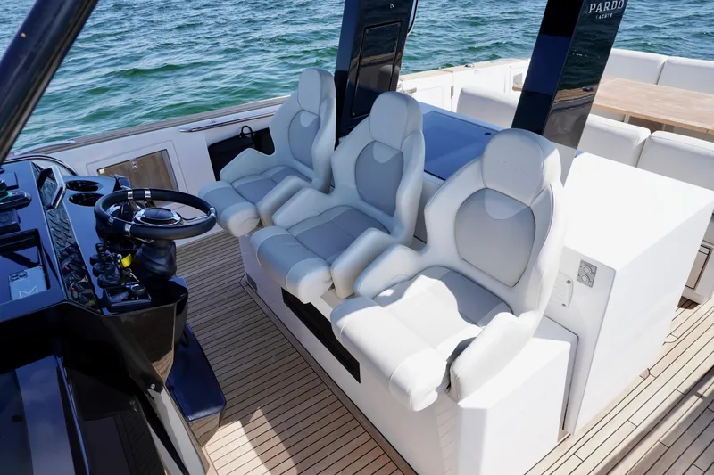 Slide: The Image of Luxury seating on 2020 Pardo Yachts 38, featuring sleek design and modern helm controls. - 15