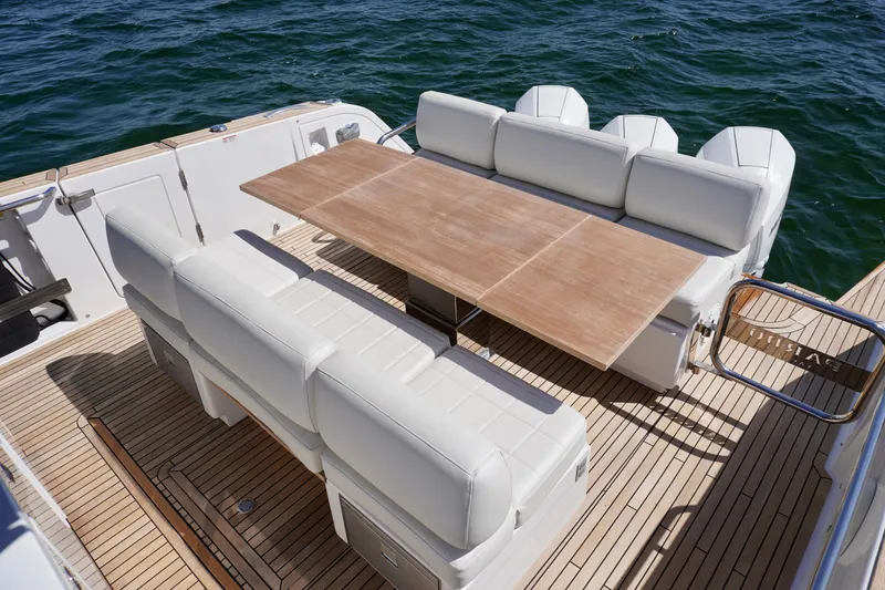 Slide: The Image of Luxury seating area on 2020 Pardo Yachts 38, featuring elegant wooden table. - 16