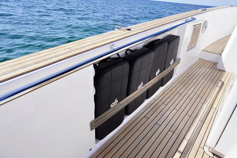 Slide: The Image of 2020 Pardo Yachts 38 with sleek deck design and cushioned seating by the sea. - 18