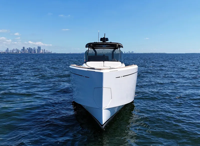 Slide: The Image of Pardo Yachts 38, 2020 model, cruising on open water with city skyline in background. - 2