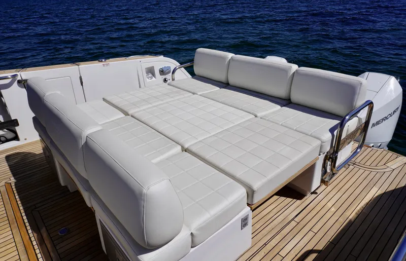 Slide: The Image of Luxurious seating area on 2020 Pardo Yachts 38, featuring white cushioned lounge, ocean backdrop. - 21