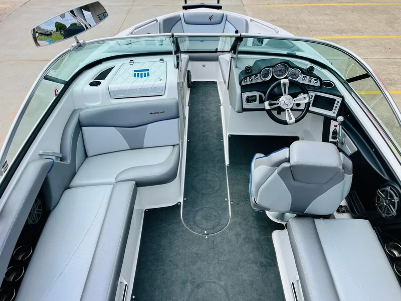 Slide: The Image of 2016 MasterCraft X30 boat interior with sleek seating and modern dashboard. - 10