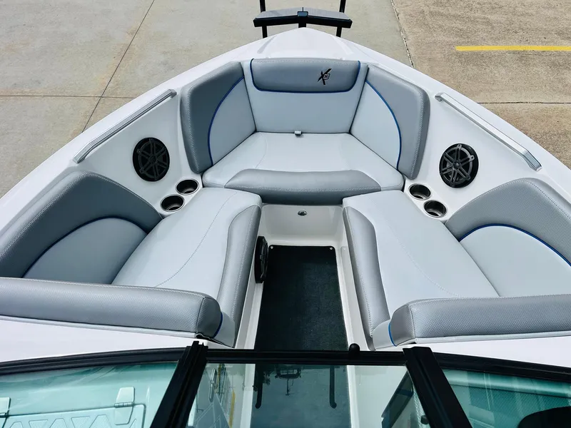 Slide: The Image of 2016 MasterCraft X30 boat interior with gray seating and built-in speakers. - 11