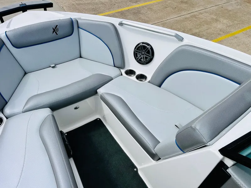 Slide: The Image of 2016 MasterCraft X30 boat interior with gray seating and speaker. - 13