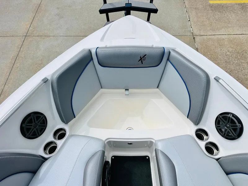 Slide: The Image of 2016 MasterCraft X30 boat interior with gray seating and cup holders. - 15