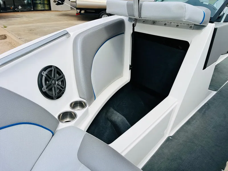 Slide: The Image of 2016 MasterCraft X30 boat interior with speaker, cup holders, and seating area. - 16