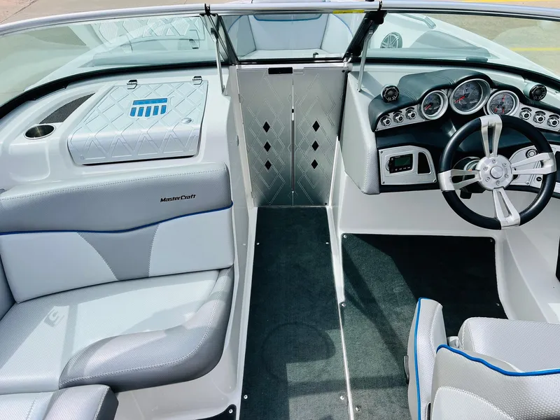 Slide: The Image of 2016 MasterCraft X30 boat interior with sleek dashboard and comfortable seating. - 18
