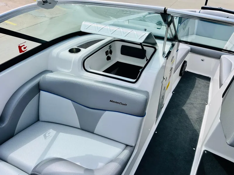 Slide: The Image of 2016 MasterCraft X30 boat interior with gray and white seating and storage compartments. - 20
