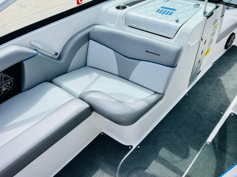Slide: The Image of 2016 MasterCraft X30 boat interior with gray and white seating. - 22