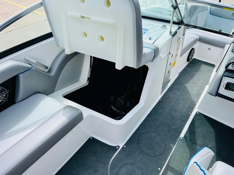 Slide: The Image of 2016 MasterCraft X30 boat interior with open storage compartment and seating. - 23