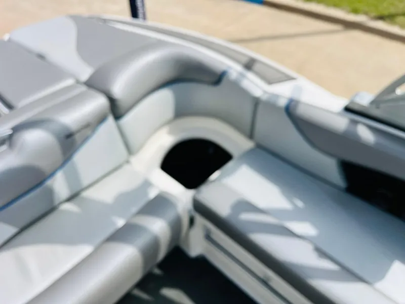 Slide: The Image of 2016 MasterCraft X30 boat interior with gray seating and storage compartment. - 27