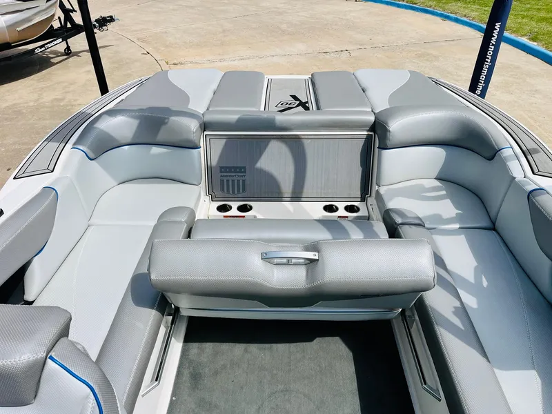 Slide: The Image of 2016 MasterCraft X30 boat interior with gray seating and cup holders. - 29