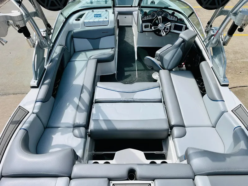 Slide: The Image of 2016 MasterCraft X30 boat interior with gray seating and modern dashboard. - 31