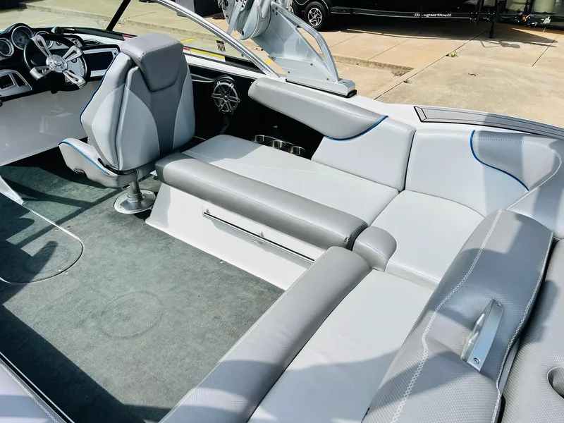 Slide: The Image of 2016 MasterCraft X30 boat interior with gray seating and modern dashboard. - 34