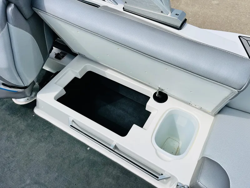 Slide: The Image of 2016 MasterCraft X30 boat seat storage compartment with cup holder, open for viewing. - 36