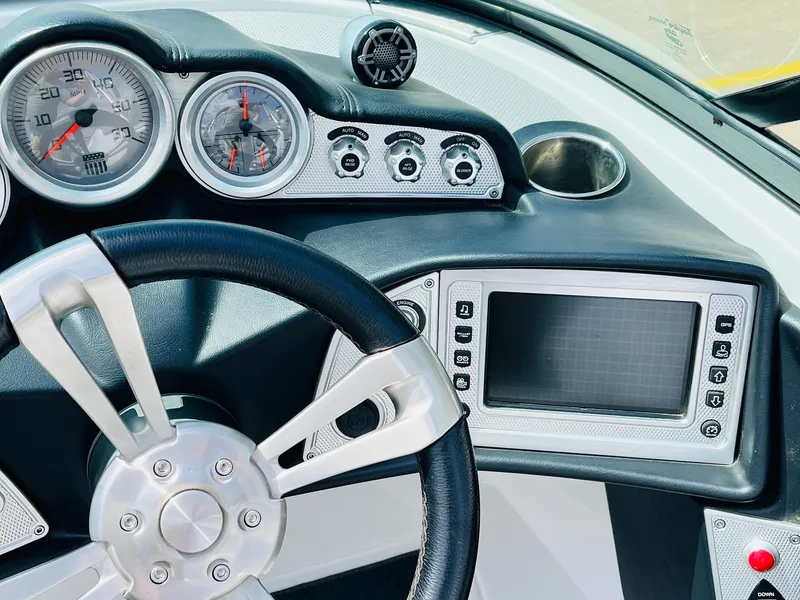 Slide: The Image of 2016 MasterCraft X30 dashboard with steering wheel, gauges, and touchscreen display. - 41