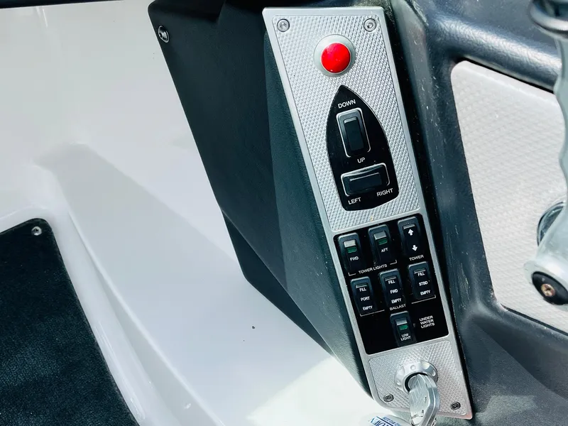 Slide: The Image of Control panel of a 2016 MasterCraft X30 boat with switches and a red button. - 42