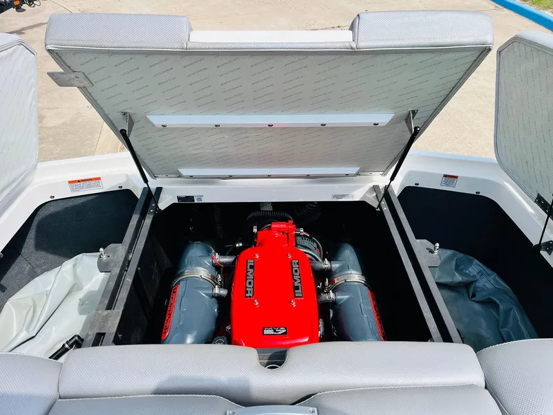 Slide: The Image of 2016 MasterCraft X30 engine compartment with red Ilmor engine, open hatch, and gray interior. - 46