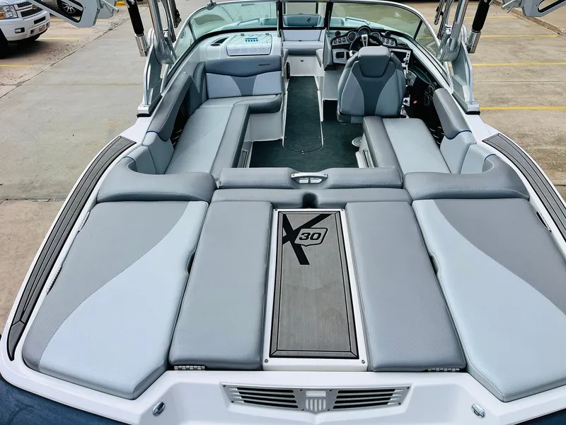 Slide: The Image of 2016 MasterCraft X30 boat interior with gray seating and sleek design. - 9