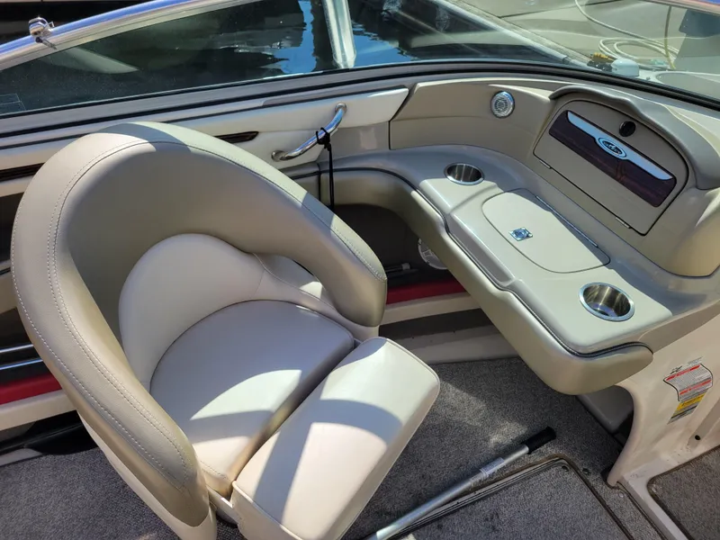 Slide: The Image of 2005 Sea Ray 200 Select boat interior with beige seating and dashboard details. - 11