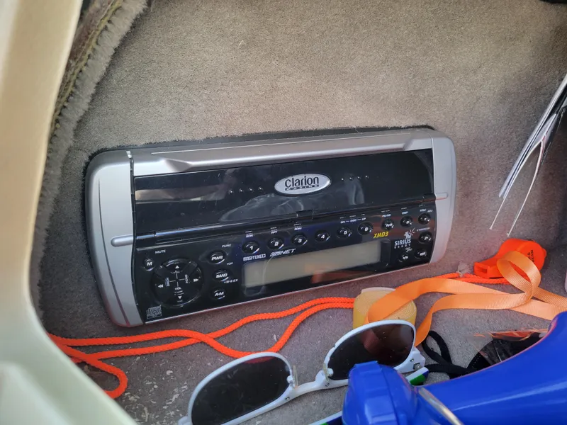 Slide: The Image of Clarion stereo system in a 2005 Sea Ray 200 Select boat, surrounded by accessories. - 12