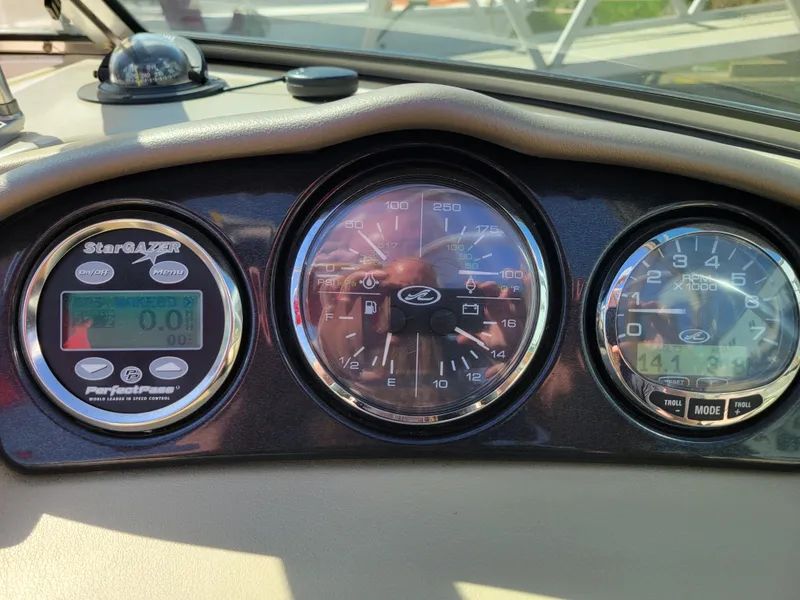 Slide: The Image of Dashboard of a 2005 Sea Ray 200 Select boat with gauges and controls. - 15
