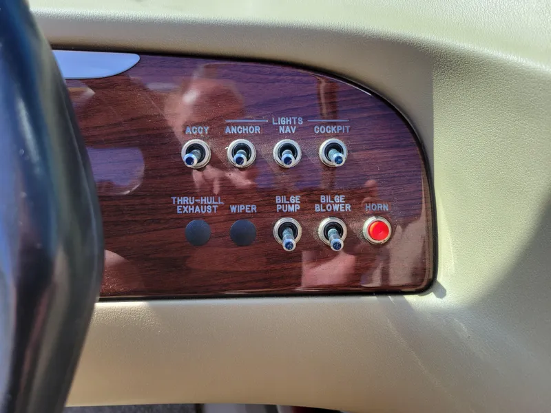 Slide: The Image of Control panel of a 2005 Sea Ray 200 Select boat with various switches. - 16