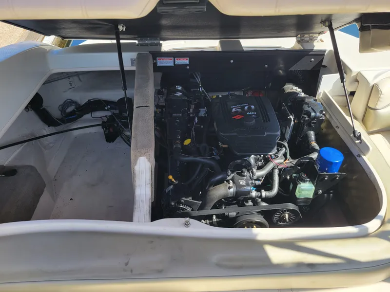 Slide: The Image of Open engine compartment of 2005 Sea Ray 200 Select boat, showcasing engine details. - 19