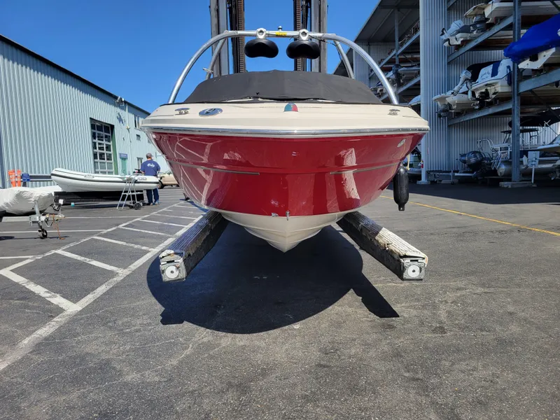 Slide: The Image of 2005 Sea Ray 200 Select boat in storage, red hull, front view. - 23