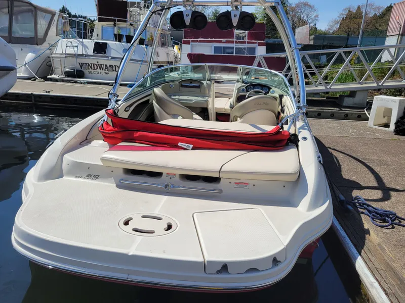 Slide: The Image of 2005 Sea Ray 200 Select boat docked, featuring spacious seating and sleek design. - 5