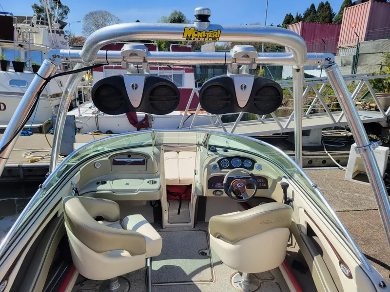 Slide: The Image of Interior of 2005 Sea Ray 200 Select boat with modern dashboard and seating. - 9