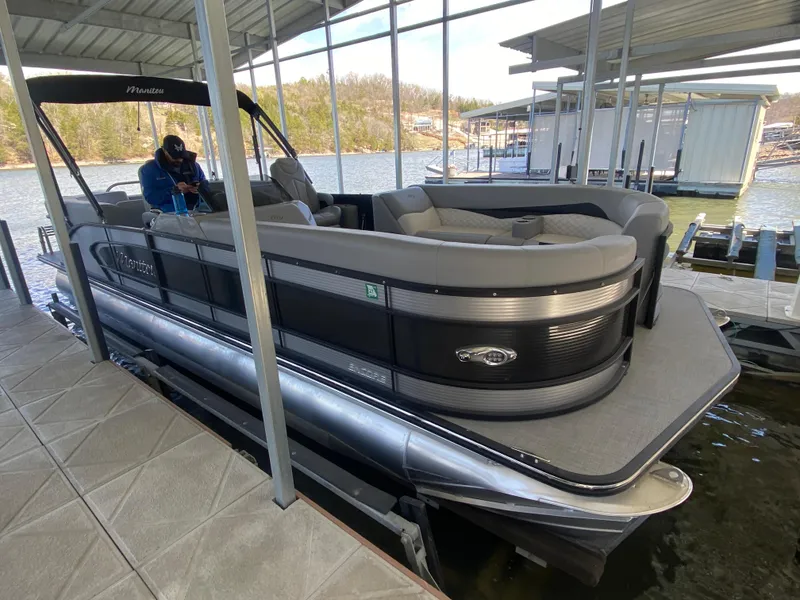 Slide: The Image of 2021 Manitou 25 Encore RF SHP Twin pontoon boat docked in a marina. - 10