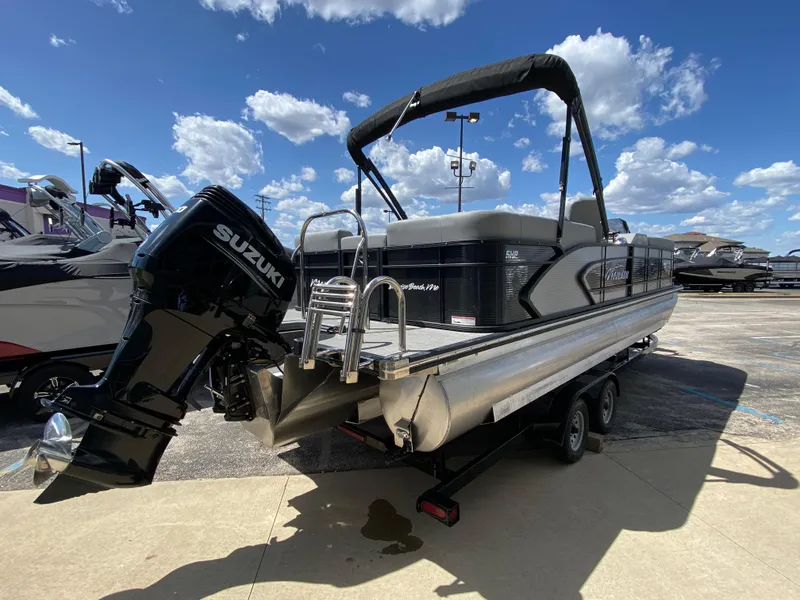 Slide: The Image of 2021 Manitou 25 Encore RF SHP Twin pontoon boat with Suzuki outboard motor. - 18
