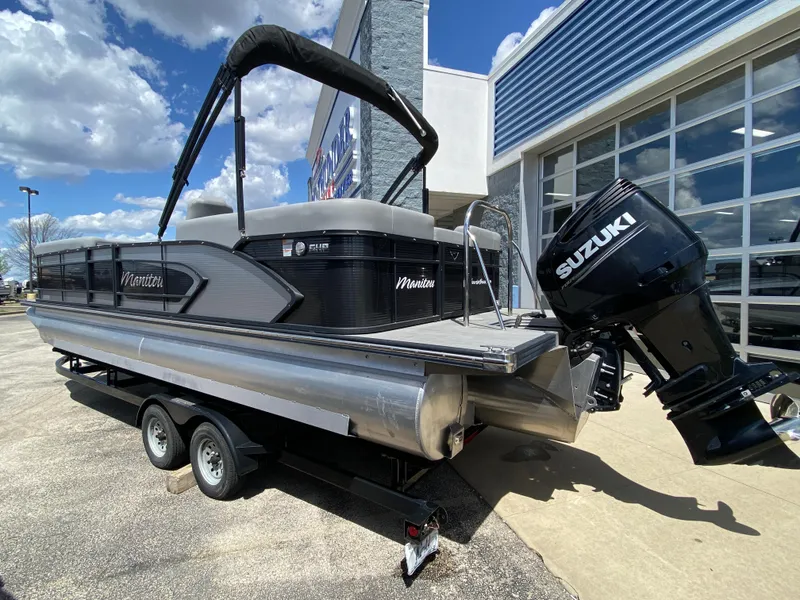 Slide: The Image of 2021 Manitou 25 Encore RF SHP Twin pontoon boat with Suzuki engine on trailer. - 20