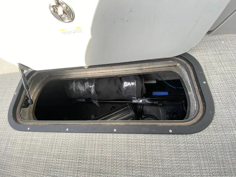 Slide: The Image of Storage compartment in 2021 Manitou 25 Encore RF SHP Twin boat, showing interior contents. - 24