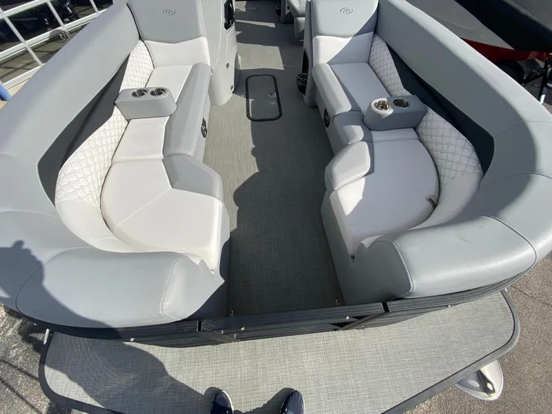 Slide: The Image of 2021 Manitou 25 Encore RF SHP Twin boat interior with gray seating and cup holders. - 25