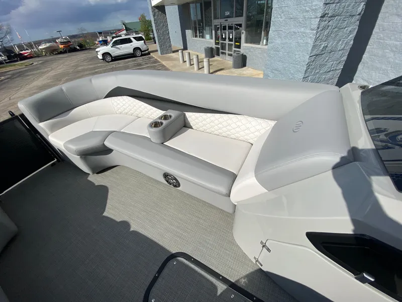 Slide: The Image of 2021 Manitou 25 Encore RF SHP Twin boat interior with gray seating and cup holders. - 28