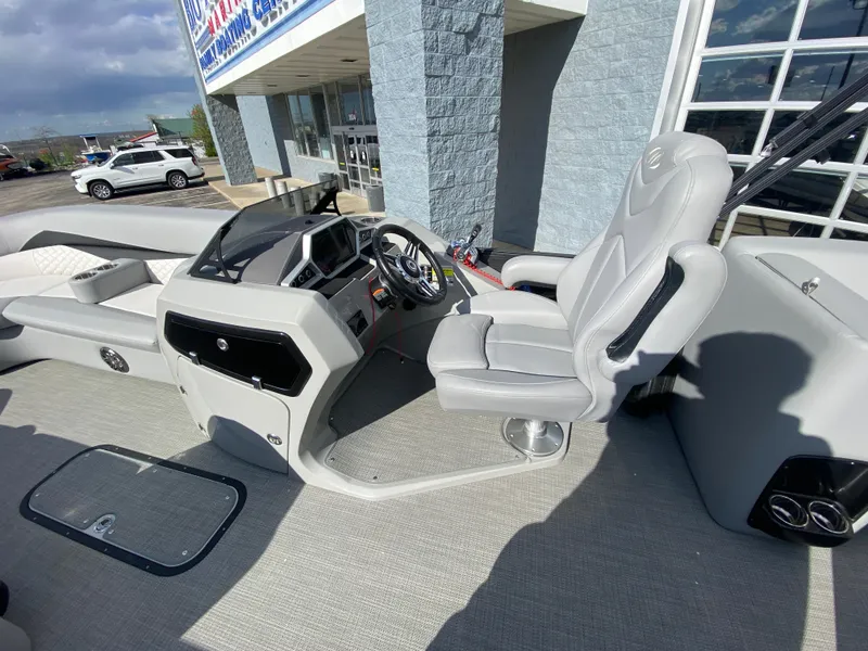 Slide: The Image of 2021 Manitou 25 Encore RF SHP Twin boat interior with steering console and seating. - 29