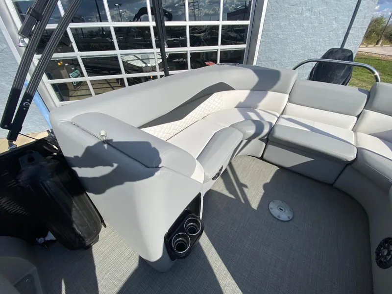 Slide: The Image of 2021 Manitou 25 Encore RF SHP Twin boat interior with gray seating and cup holders. - 42