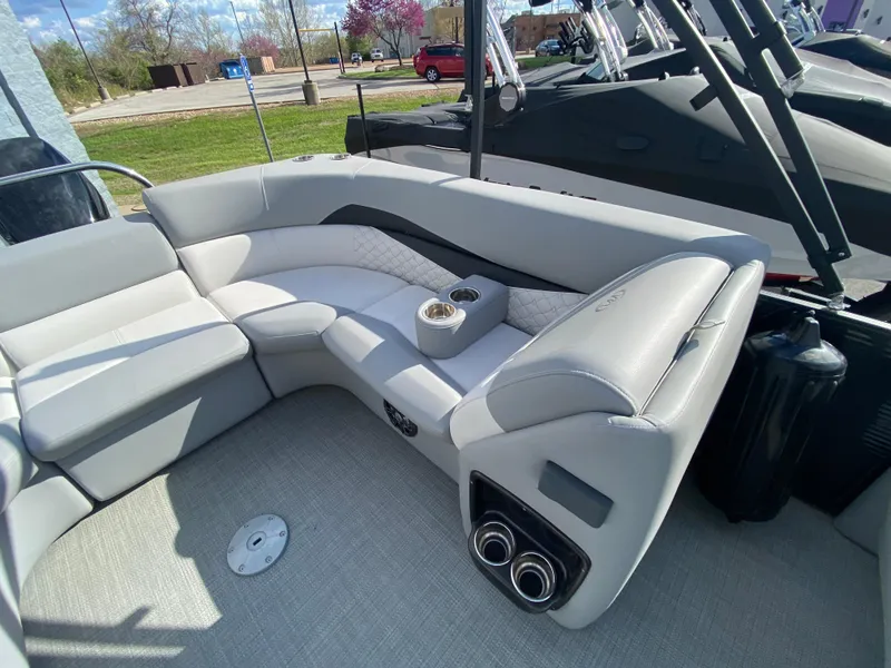 Slide: The Image of 2021 Manitou 25 Encore RF SHP Twin boat interior with plush seating and cup holders. - 43