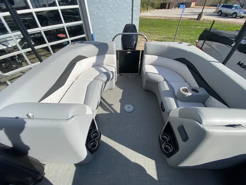 Slide: The Image of 2021 Manitou 25 Encore RF SHP Twin boat interior with gray seating and cup holders. - 44