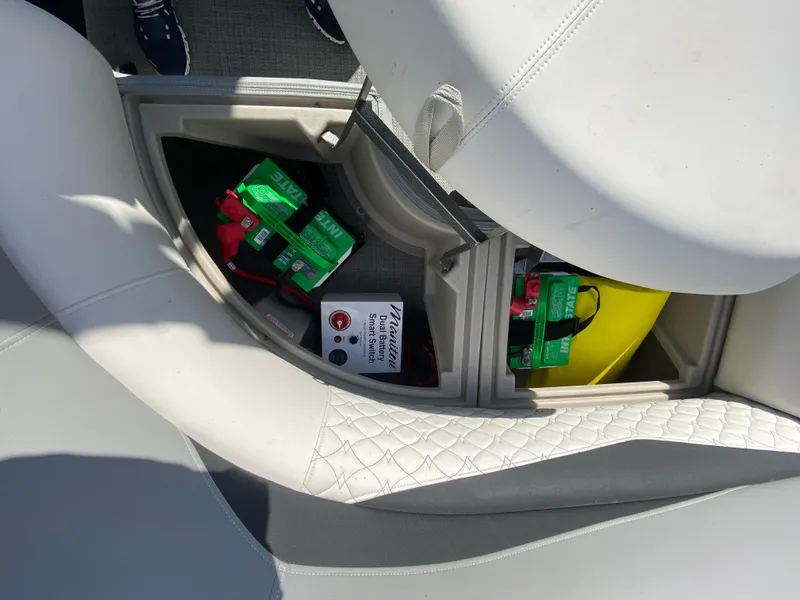 Slide: The Image of Storage compartment in 2021 Manitou 25 Encore RF SHP Twin boat with batteries and accessories. - 45