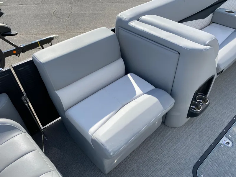 Slide: The Image of 2021 Manitou 25 Encore RF SHP Twin boat interior with gray seating and cup holders. - 47