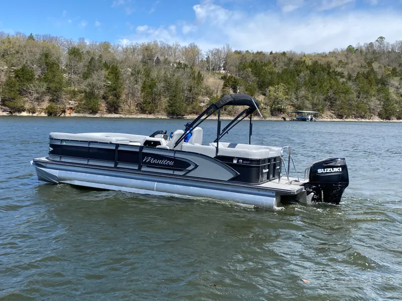 Slide: The Image of 2021 Manitou 25 Encore RF SHP Twin pontoon boat on a scenic lake. - 5