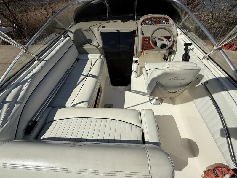 Slide: The Image of 1997 Bayliner 2655 Ciera Sunbridge interior with white seating and steering console. - 12