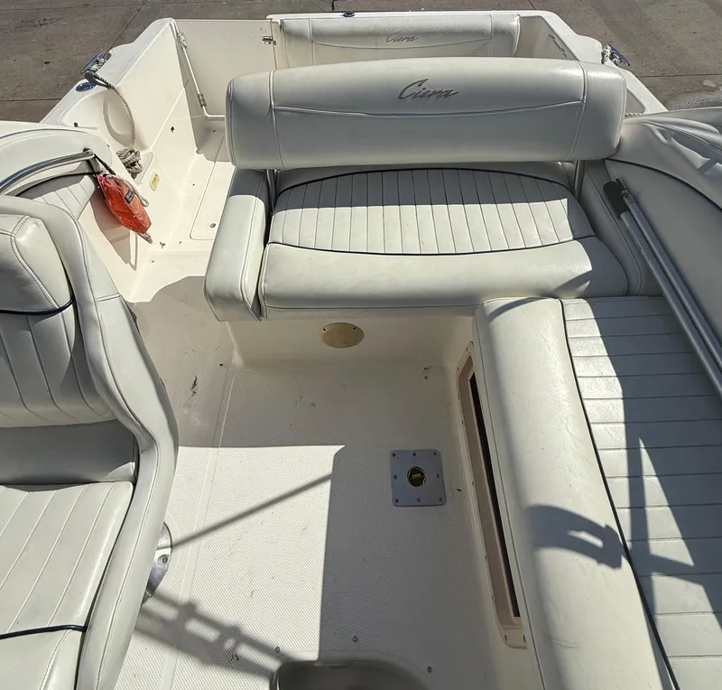 Slide: The Image of 1997 Bayliner 2655 Ciera Sunbridge boat interior with white seating and clean deck. - 13